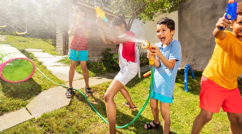 Kids Playing In Water & Hose